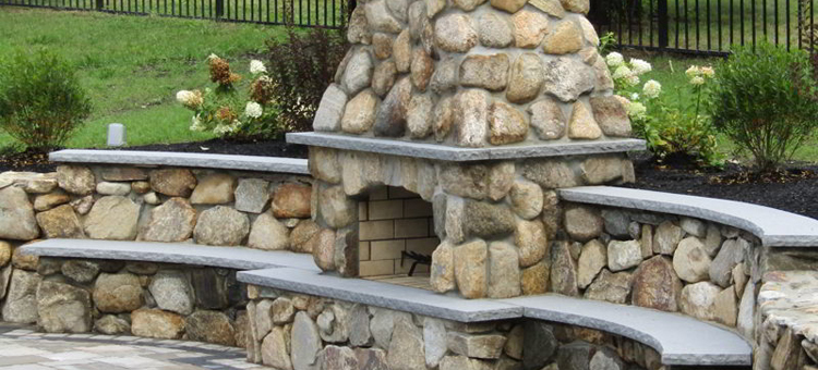 Round stone fireplace with bench seating